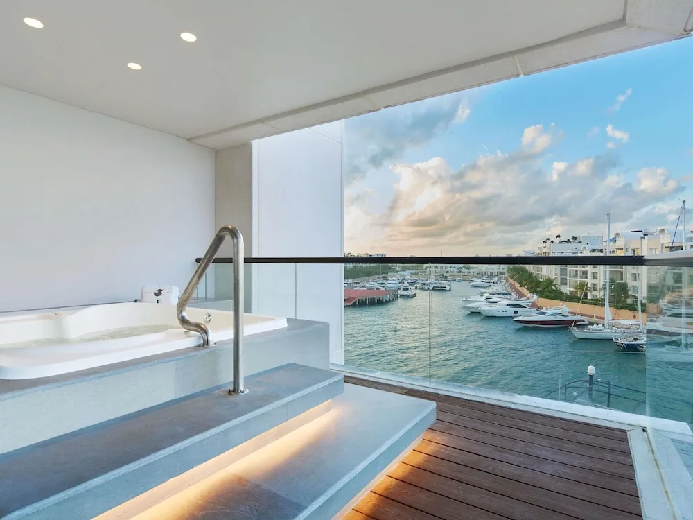 Balcony plunge pool overlooking a marina at SLS Playa Mujeres.