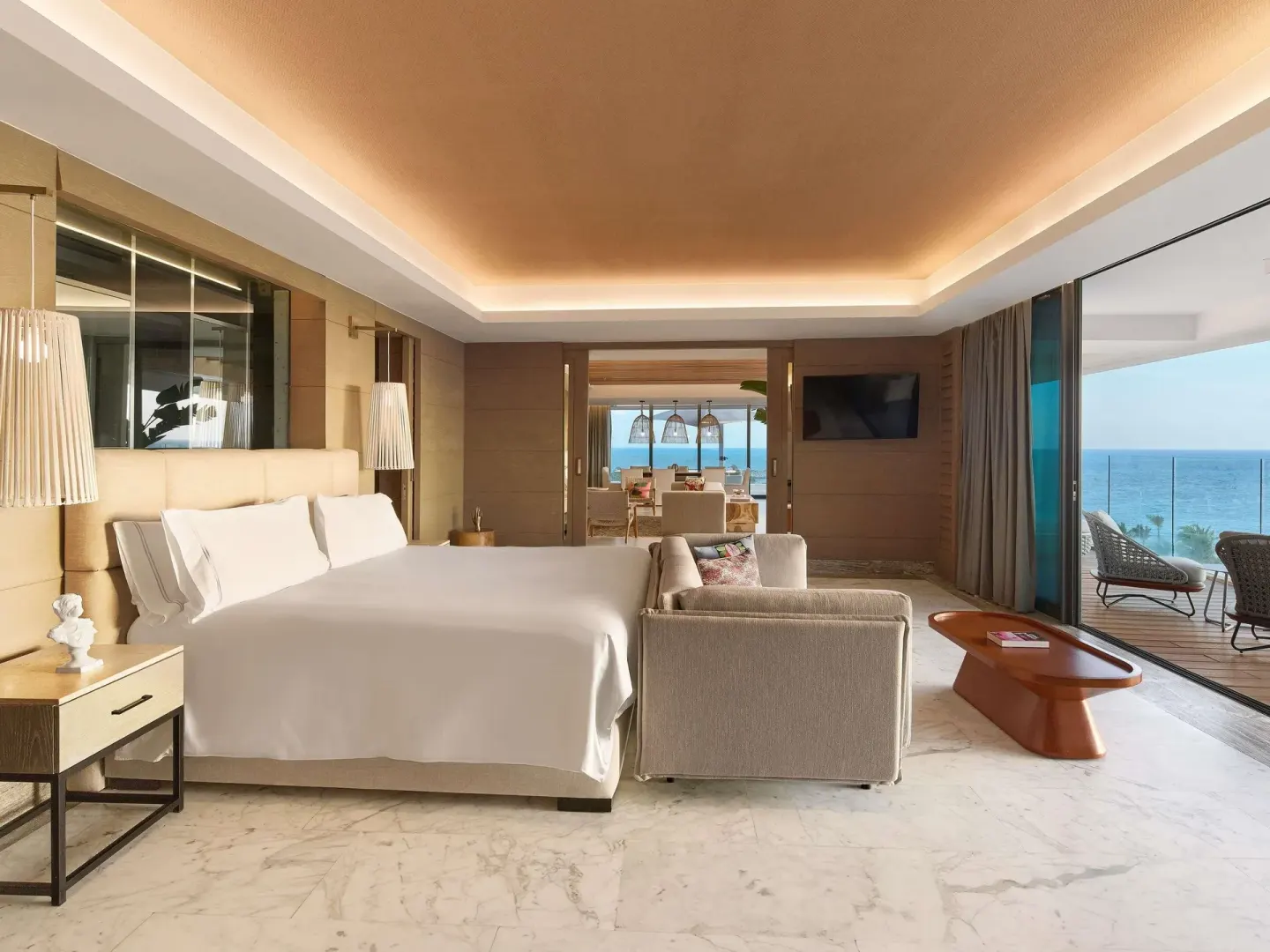 Oceanfront king bedroom suite with balcony seating at SLS Playa Mujeres.