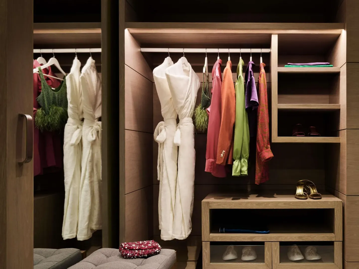 Walk-in closet with robes, clothing, shelves, and shoes at SLS Playa Mujeres.
