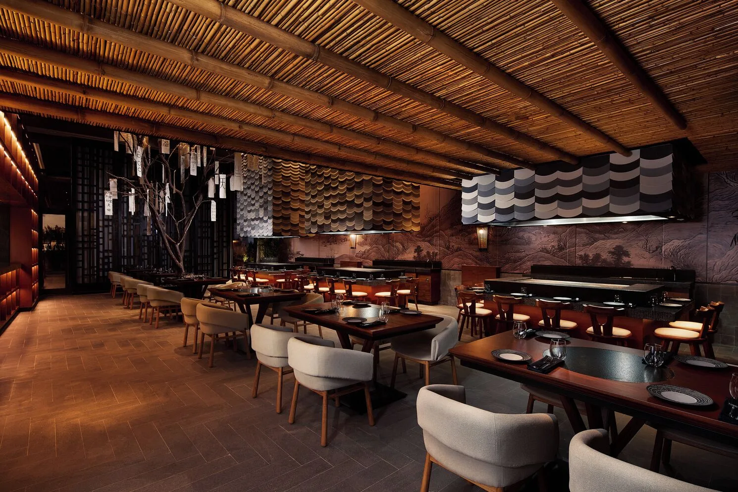 A Japanese-style dining room with bamboo ceiling and set tables at SLS Playa Mujeres.