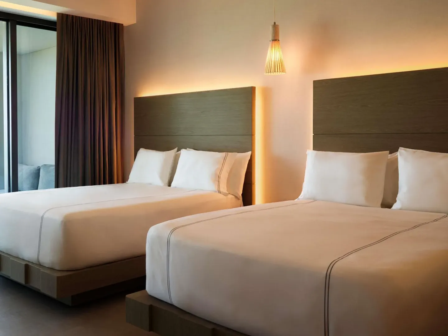 Two queen beds in a Captivate Swim-Out Two guest room at SLS Playa Mujeres.