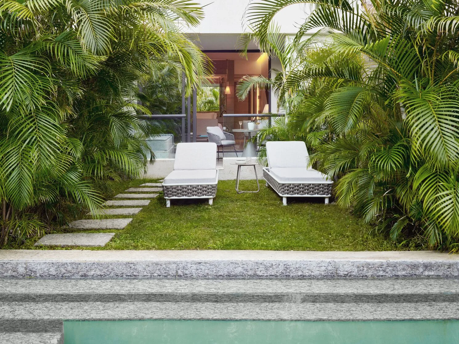 Captivate Swim-Out garden patio with two loungers at SLS Playa Mujeres.