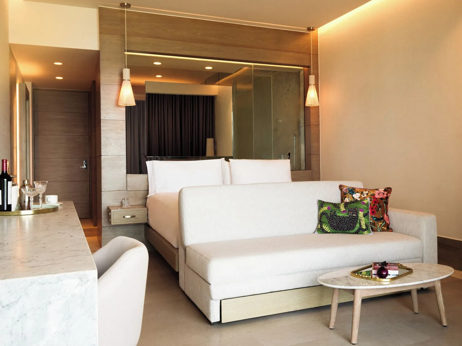 Captivate Swim-Out room with king bed and sofa at SLS Playa Mujeres.
