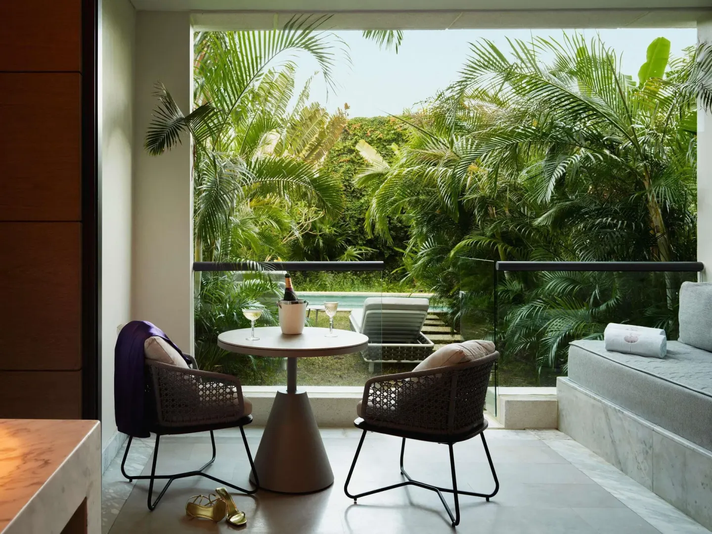Captivate Swim-Out terrace seating with garden and pool views at SLS Playa Mujeres.