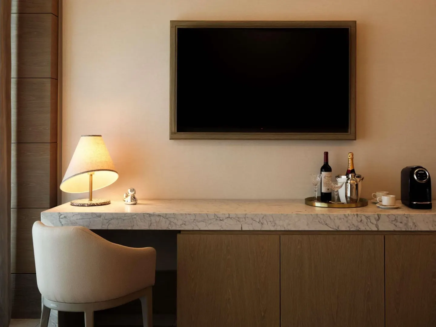 Delight guest room desk, TV, and refreshment counter at SLS Playa Mujeres.