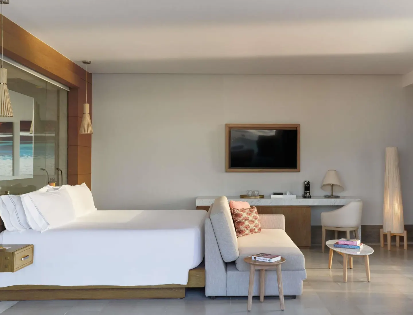 Euphoria Corner Suite Marina View bed, sofa, and desk at SLS Playa Mujeres.