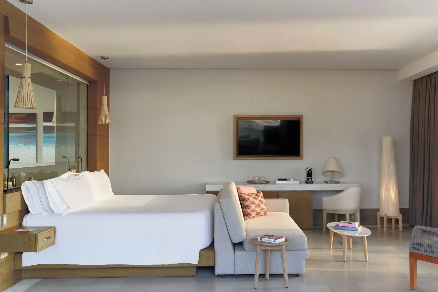 Euphoria Corner Suite Marina View king bed and sitting area at SLS Playa Mujeres.