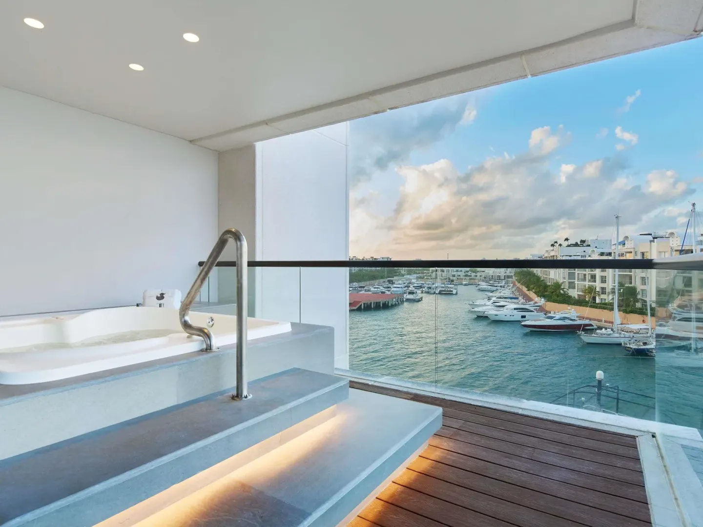 Balcony soaking tub with marina view in the Euphoria Corner Suite Ocean View at SLS Playa Mujeres.