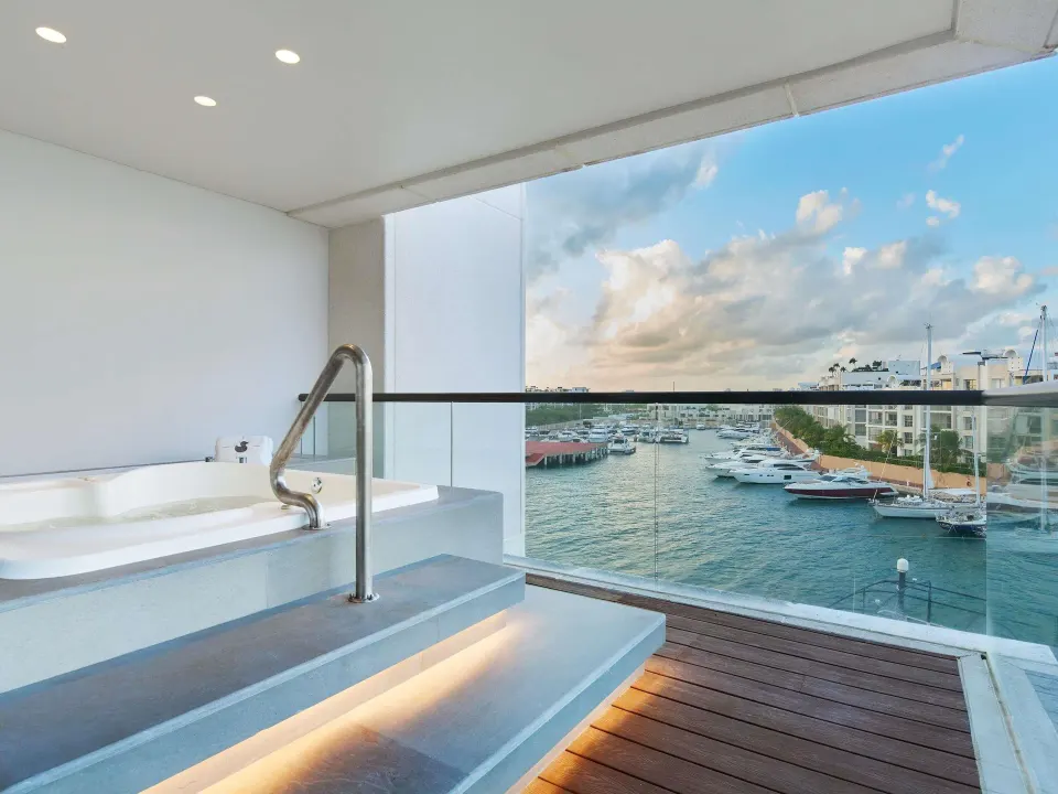 Balcony soaking tub with marina view in the Euphoria Corner Suite Ocean View at SLS Playa Mujeres.