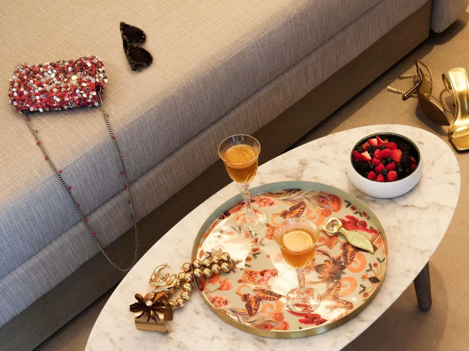 Euphoria Suite lounge table with drinks, fruit, and accessories at SLS Playa Mujeres.