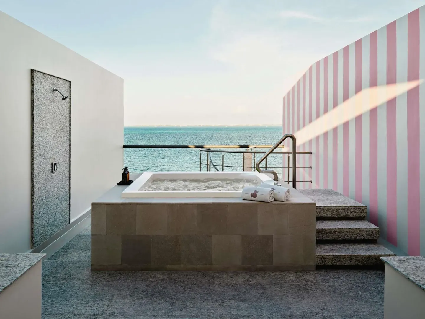 Rooftop hot tub and outdoor shower in an SLS Playa Mujeres room at SLS Playa Mujeres.