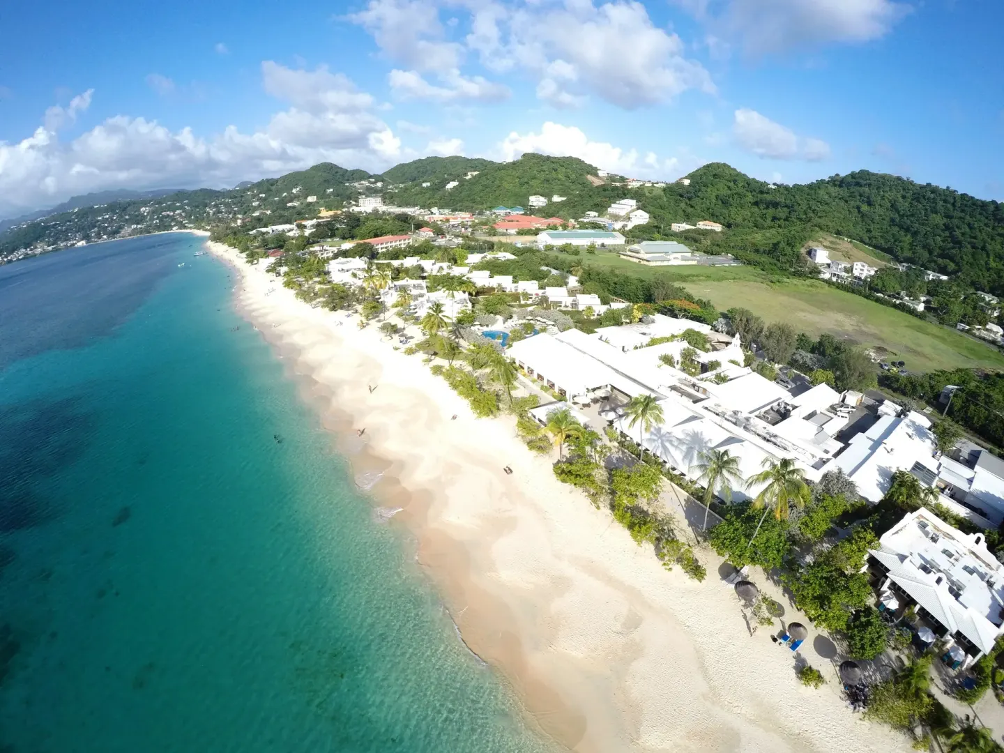 Aerial view of the beach and resort buildings at Spice Island Beach Resort.