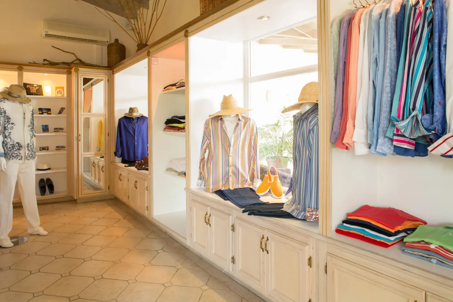 Boutique display of shirts, hats, and resort wear at Spice Island Beach Resort.