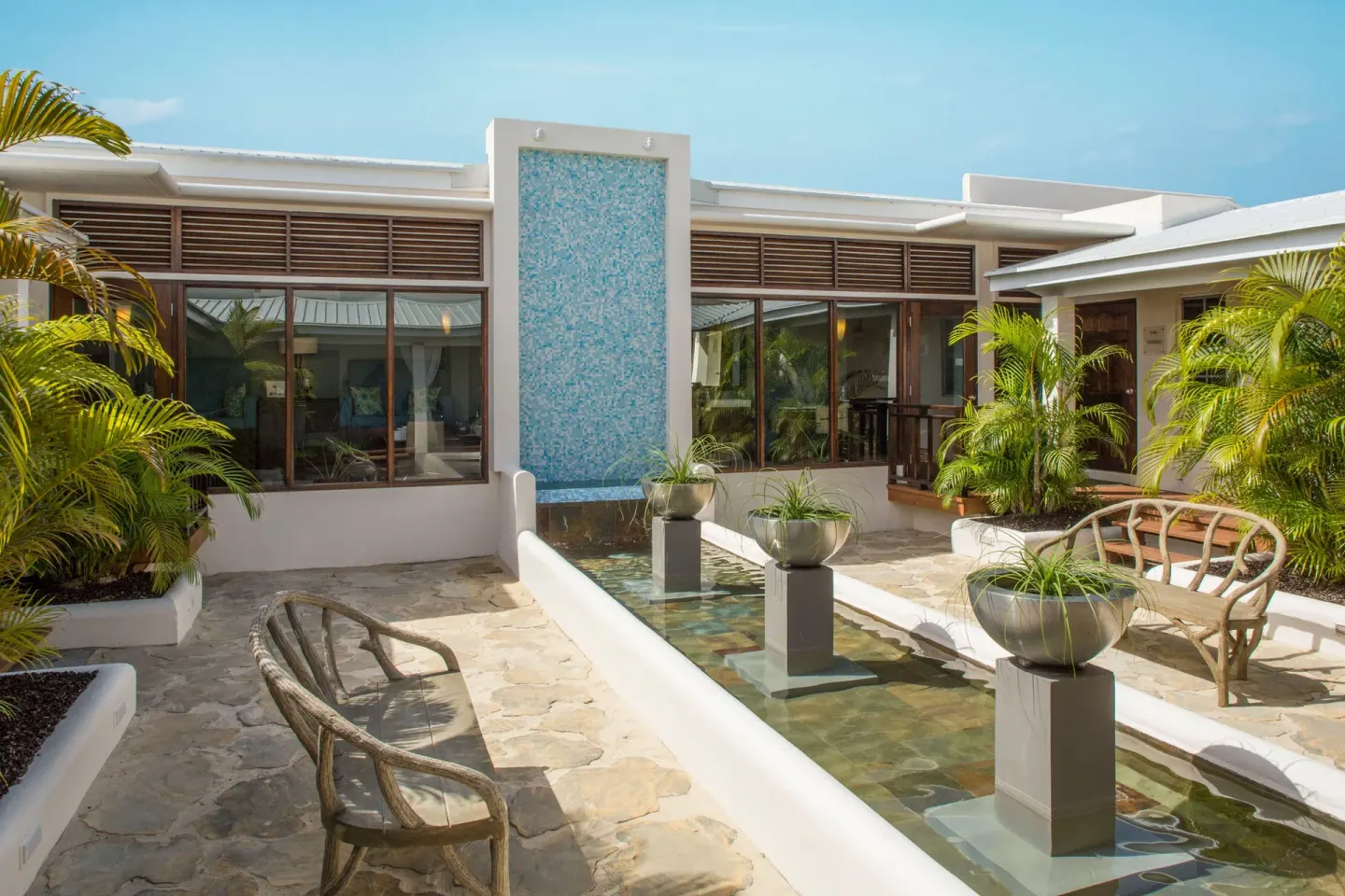 Courtyard water feature and seating at Spice Island Beach Resort.