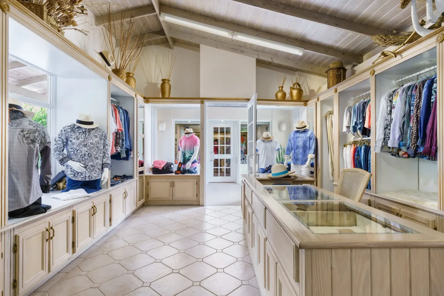 Resort boutique with men's clothing displays and glass cases at Spice Island Beach Resort.