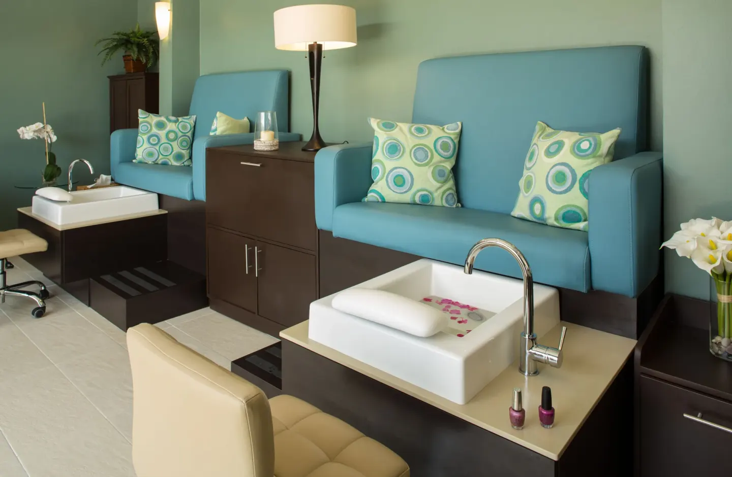 Pedicure stations with blue benches and white foot basins at Spice Island Beach Resort.