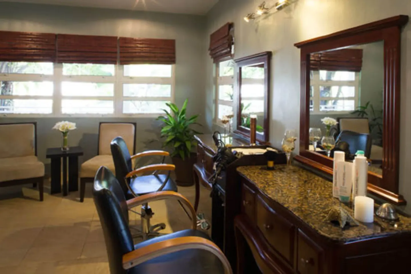 Salon chairs, mirrors, and product displays in the spa at Spice Island Beach Resort.