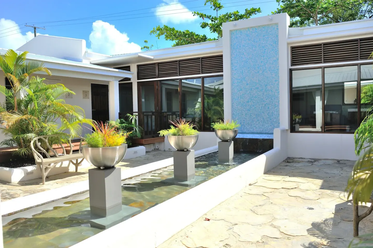 Sunny courtyard with reflecting pool at Spice Island Beach Resort.