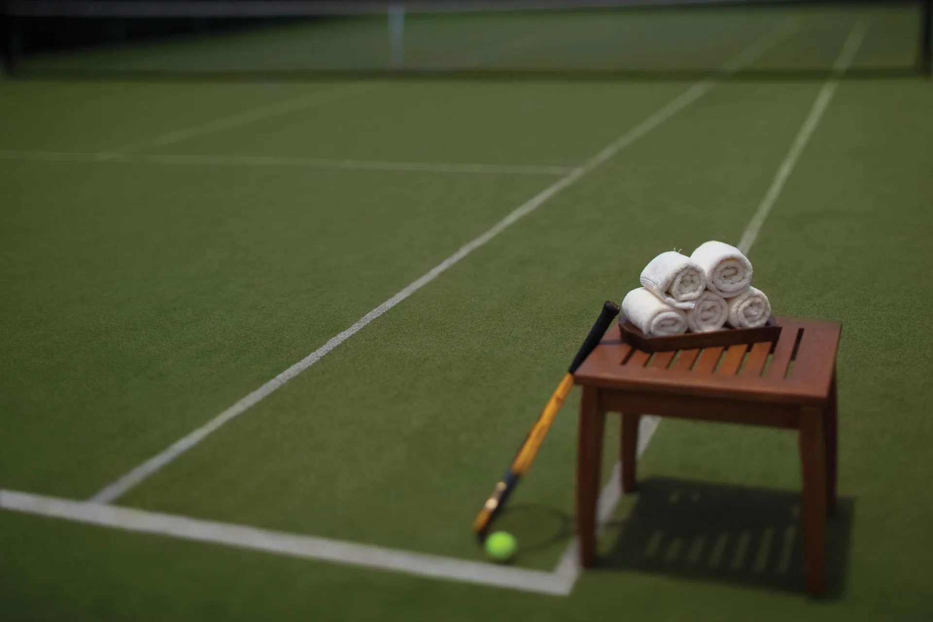 Tennis court with towels and a racket at Spice Island Beach Resort.