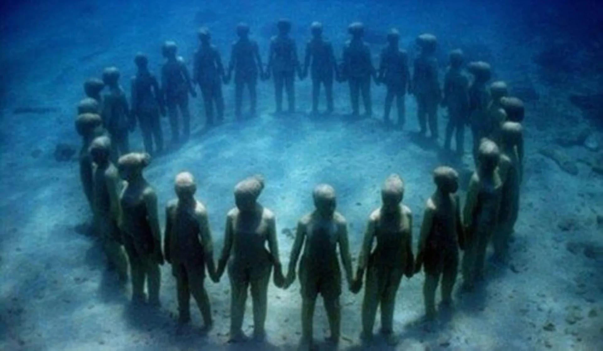 Underwater circle of human sculptures near Spice Island Beach Resort.
