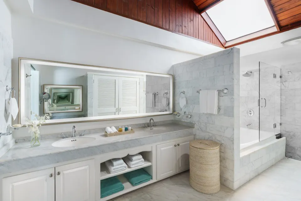 Royal Collection Pool Suite bathroom with double vanity at Spice Island Beach Resort.