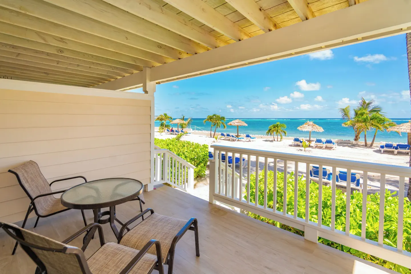 Beachfront balcony with chairs and ocean view at St. James's Club Antigua.