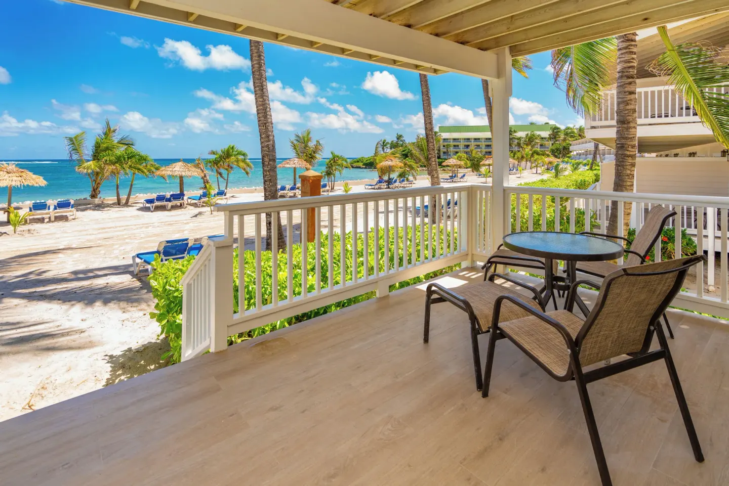 Ground-floor beachfront patio with table and beach view at St. James's Club Antigua.