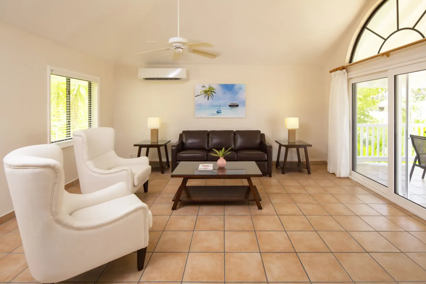 Bright resort living room with sofas and balcony doors at St. James's Club Antigua.