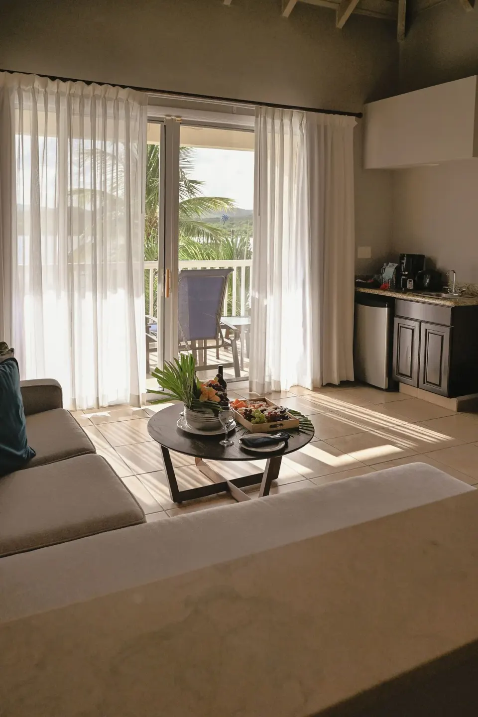 Suite living area with balcony and kitchenette at St. James's Club Antigua.