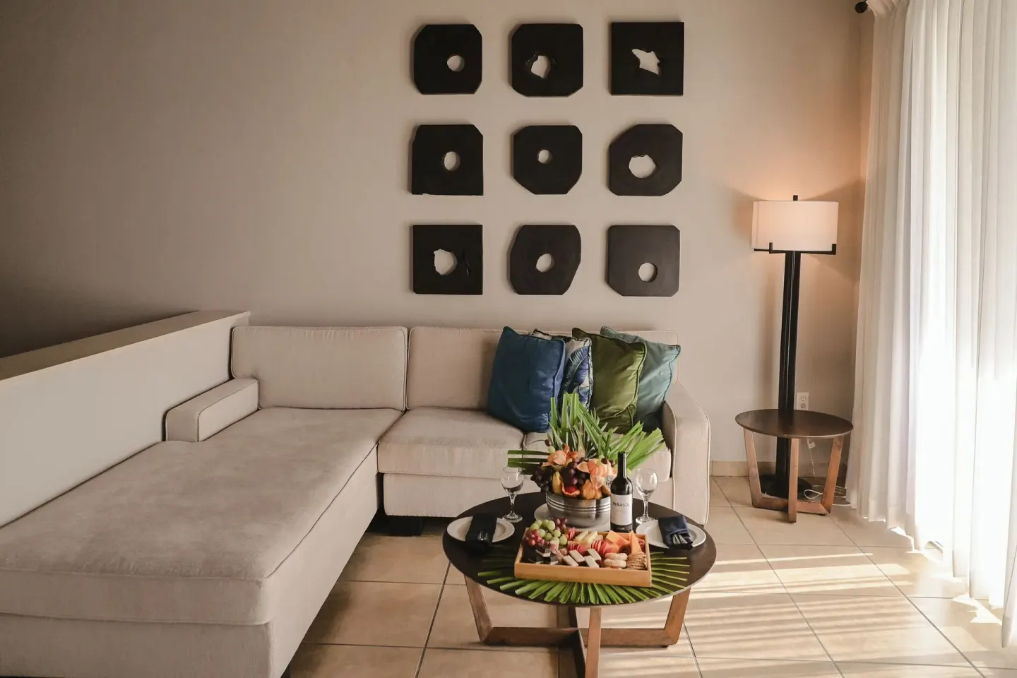 Suite sitting area with sectional sofa and welcome tray at St. James's Club Antigua.