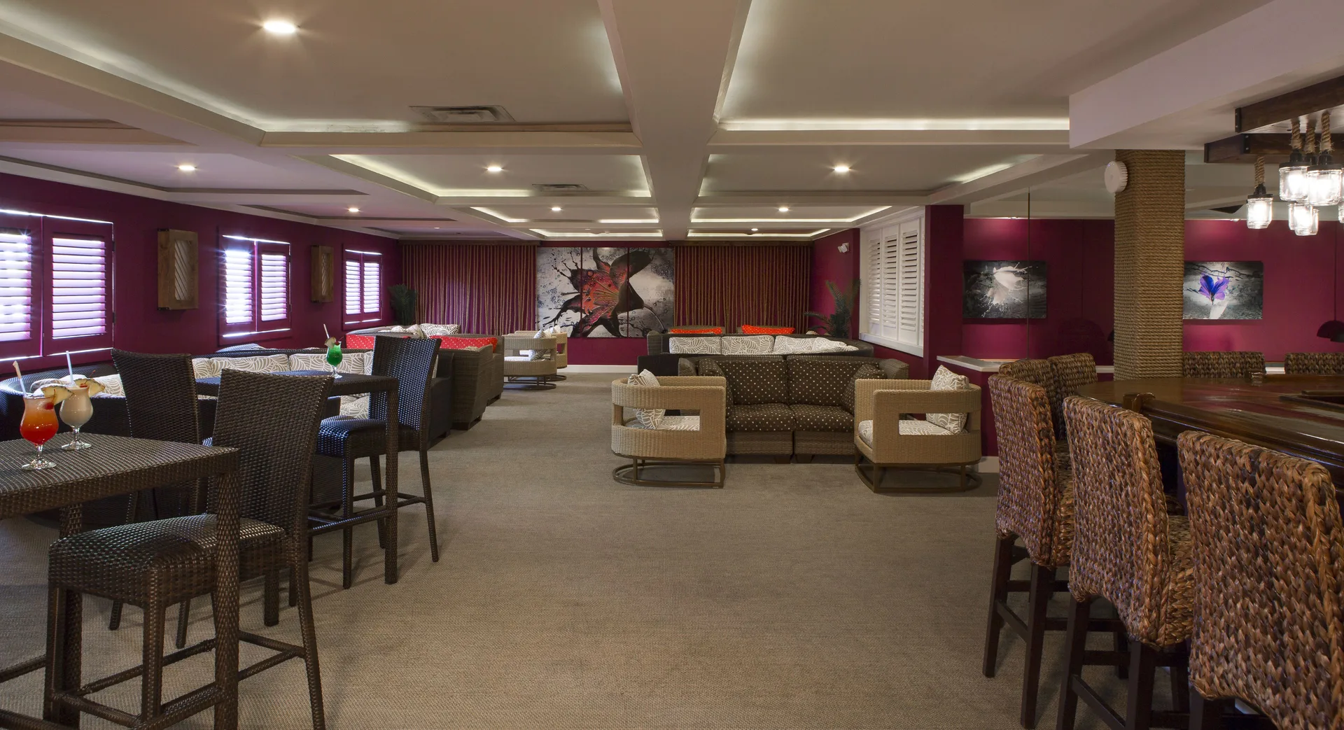 Lounge seating and bar area with magenta walls at St. James's Club Antigua.