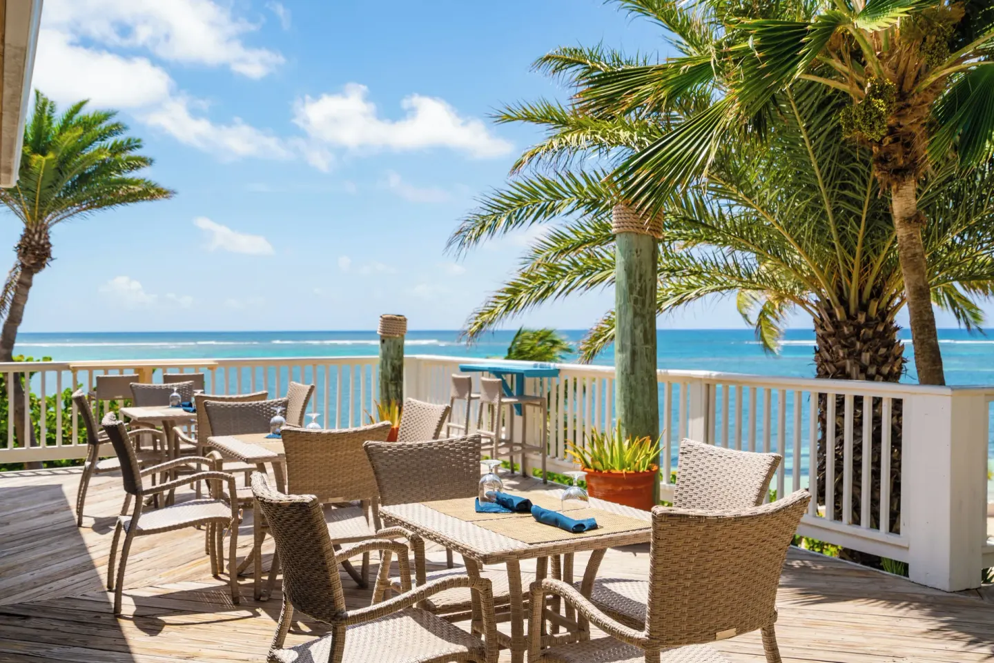 Oceanview terrace dining with wicker chairs at St. James's Club Antigua.