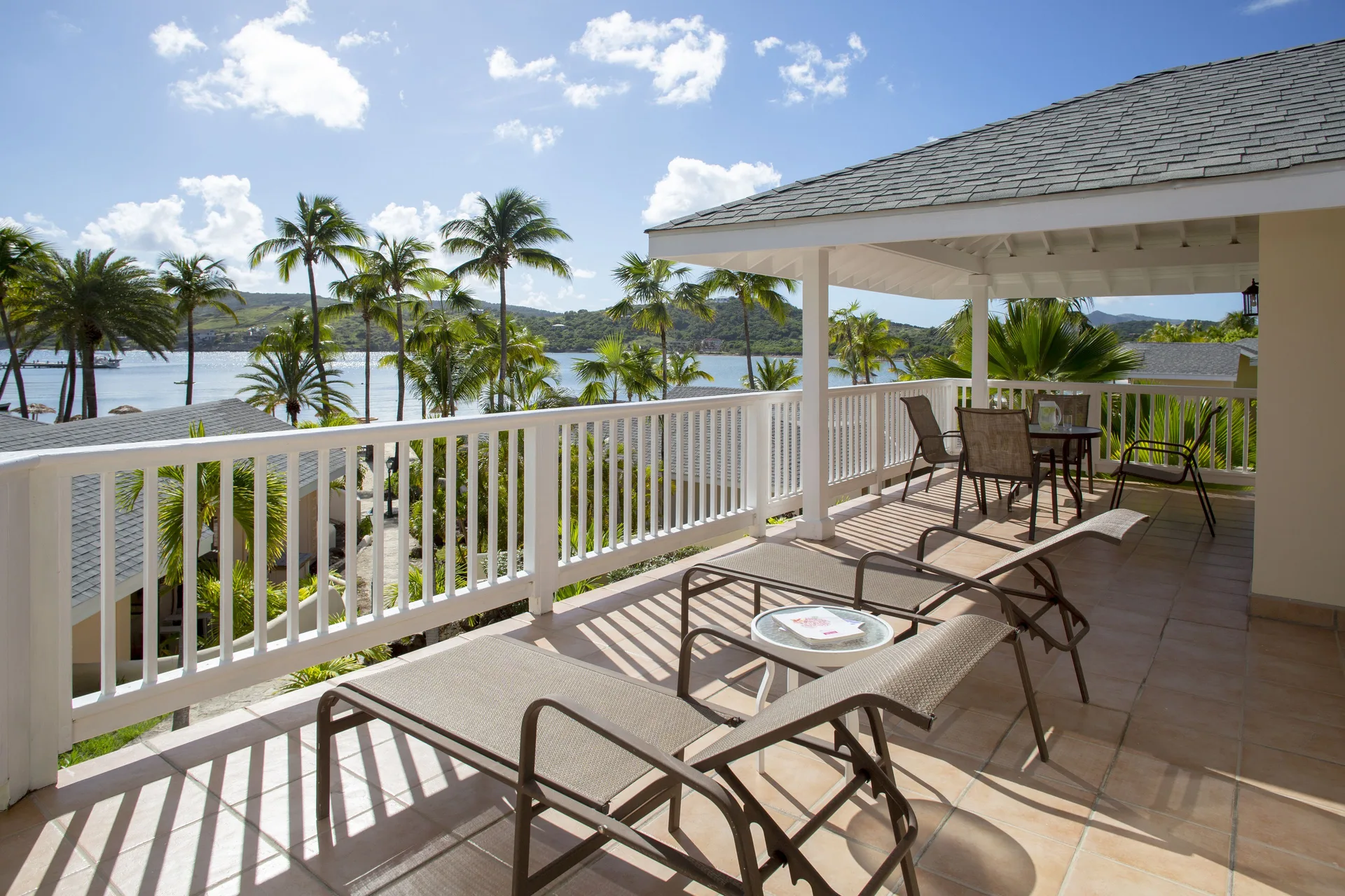 2 Bedroom Villa balcony with loungers and bay view at St. James's Club Antigua.