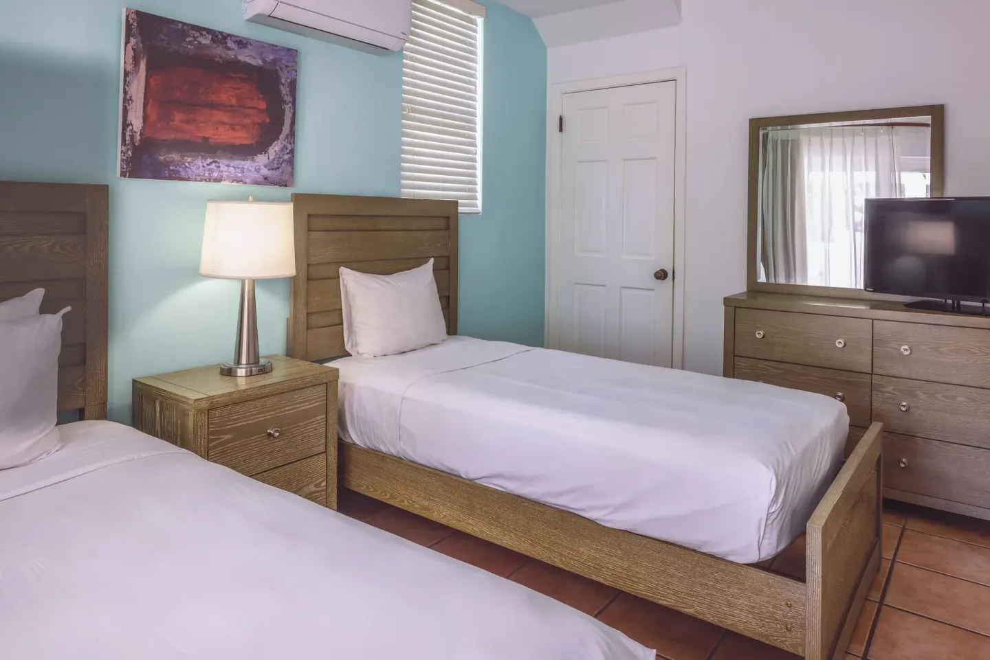 2 Bedroom Villa twin bedroom with two beds and dresser at St. James's Club Antigua.