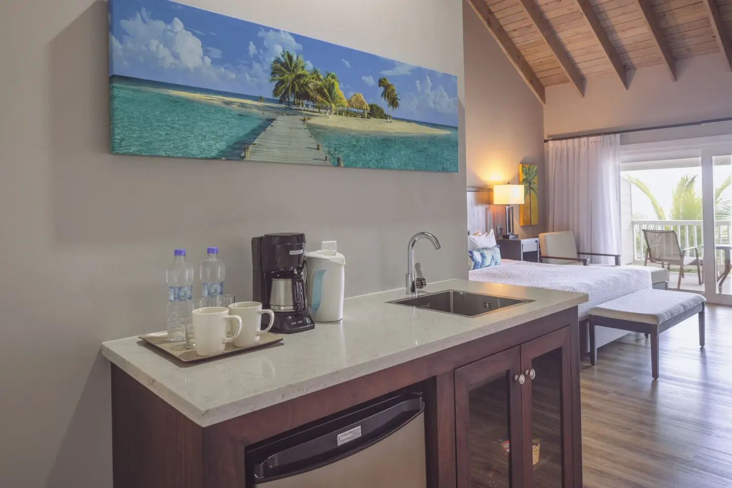 Beachfront Room wet bar with coffee maker and bedroom beyond at St. James's Club Antigua.