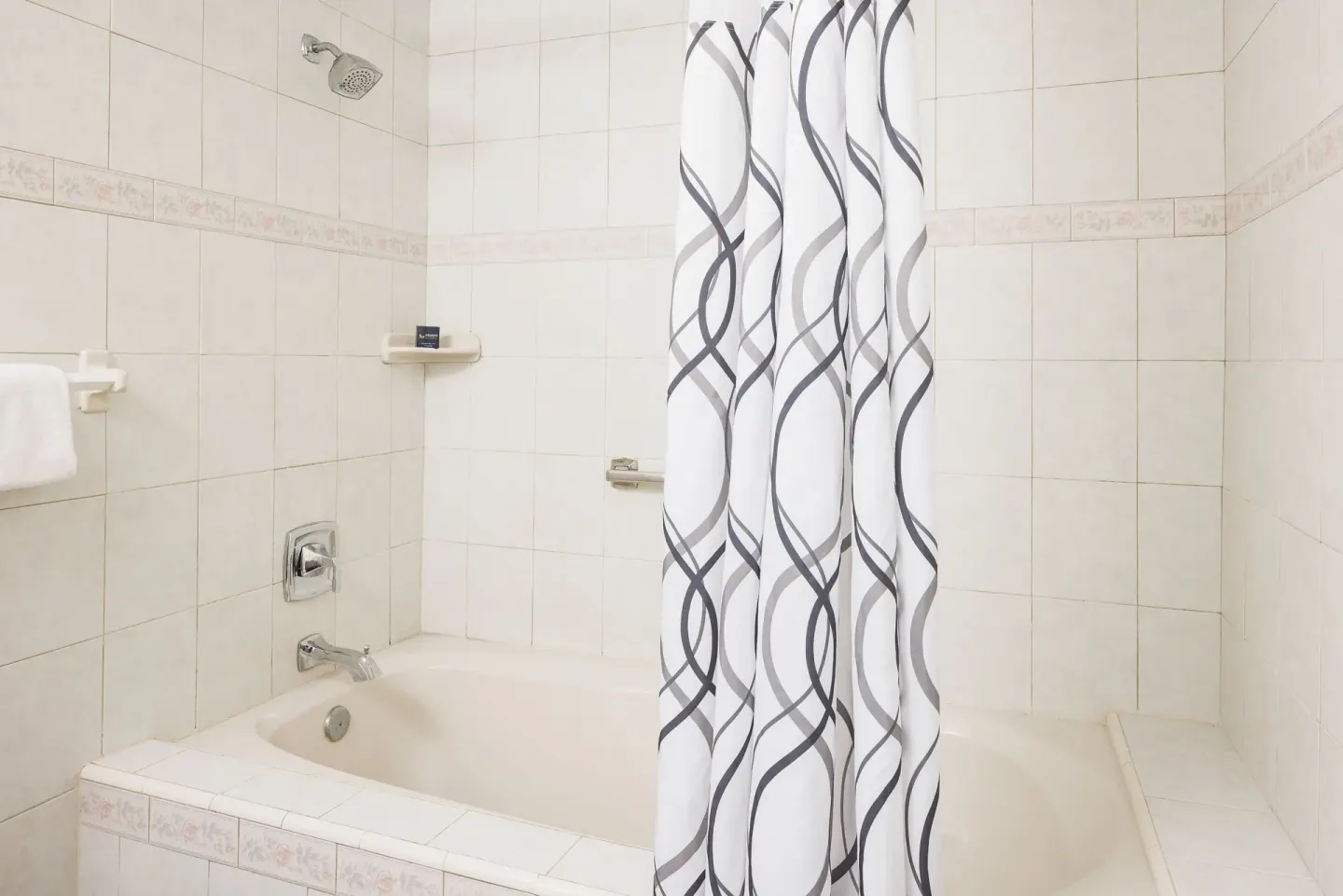 Club Room bathroom tub and shower curtain at St. James's Club Antigua.