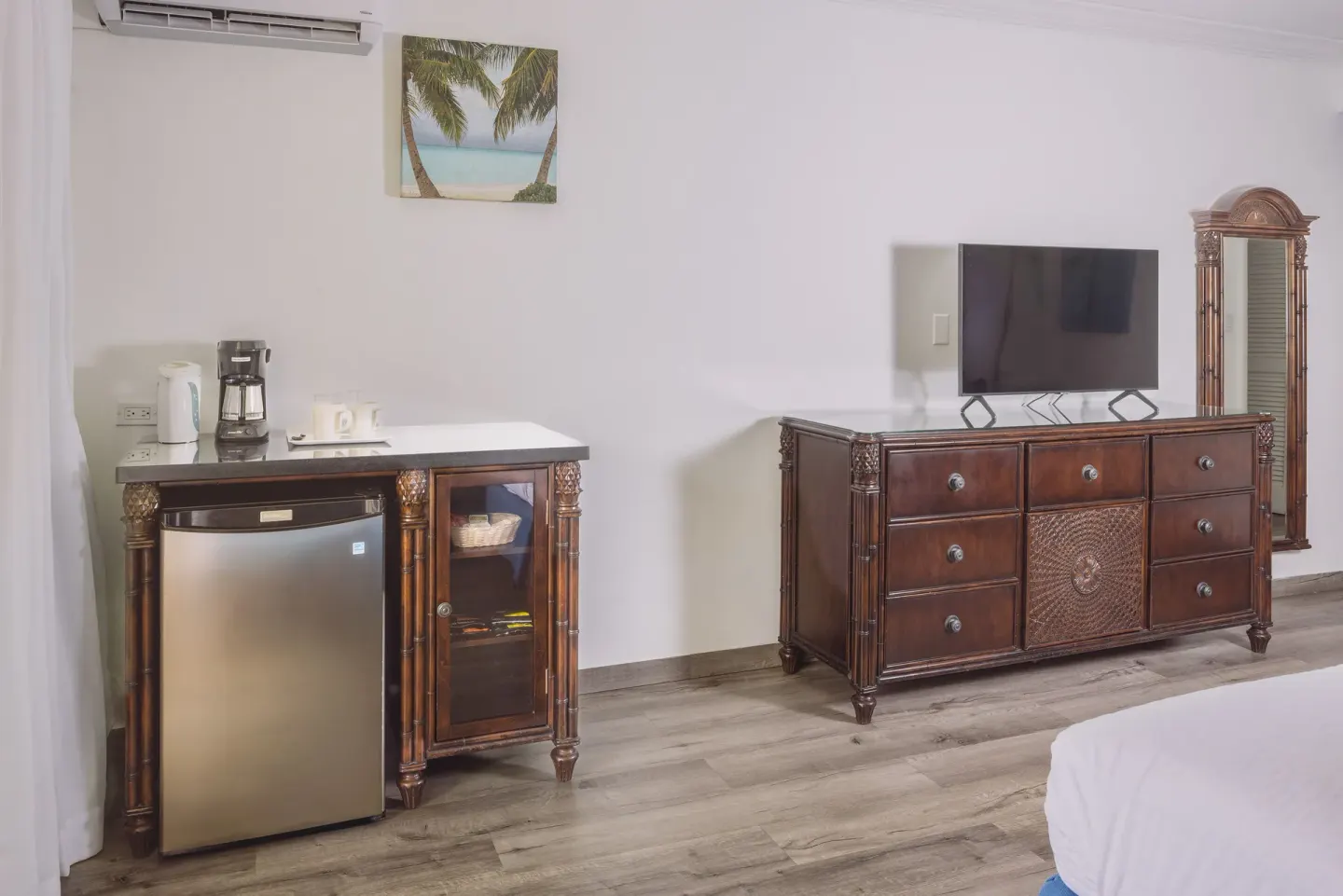 Club Room dresser, TV, mini fridge, and coffee station at St. James's Club Antigua.