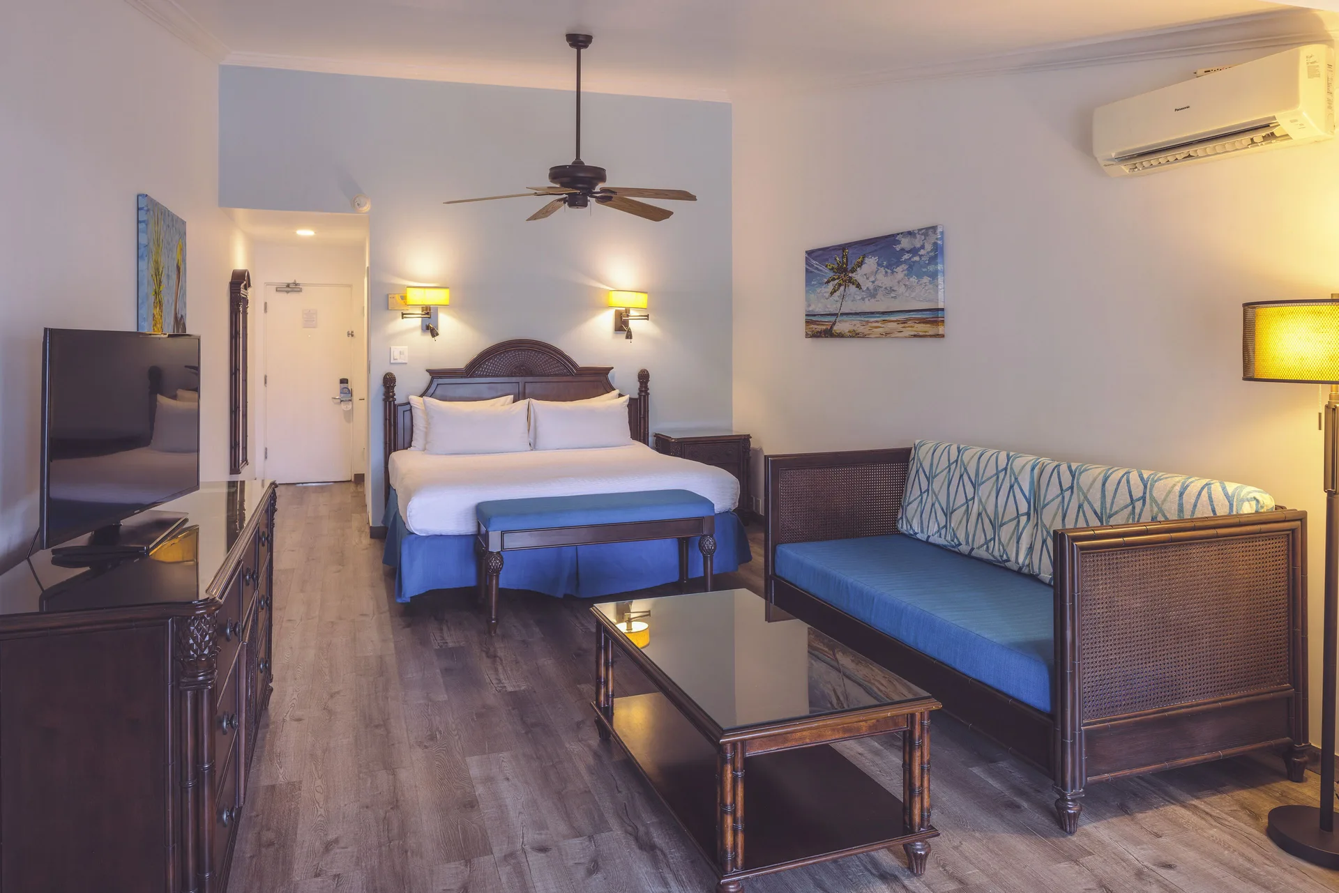 Junior Suite at St. James's Club Antigua with king bed, separate sofa area, TV, and enhanced comfort on the peninsula.