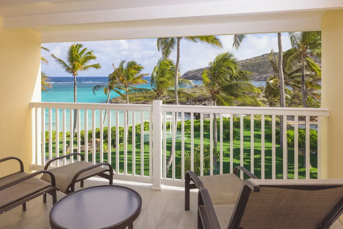 Junior Suite balcony with palm and sea view at St. James's Club Antigua.