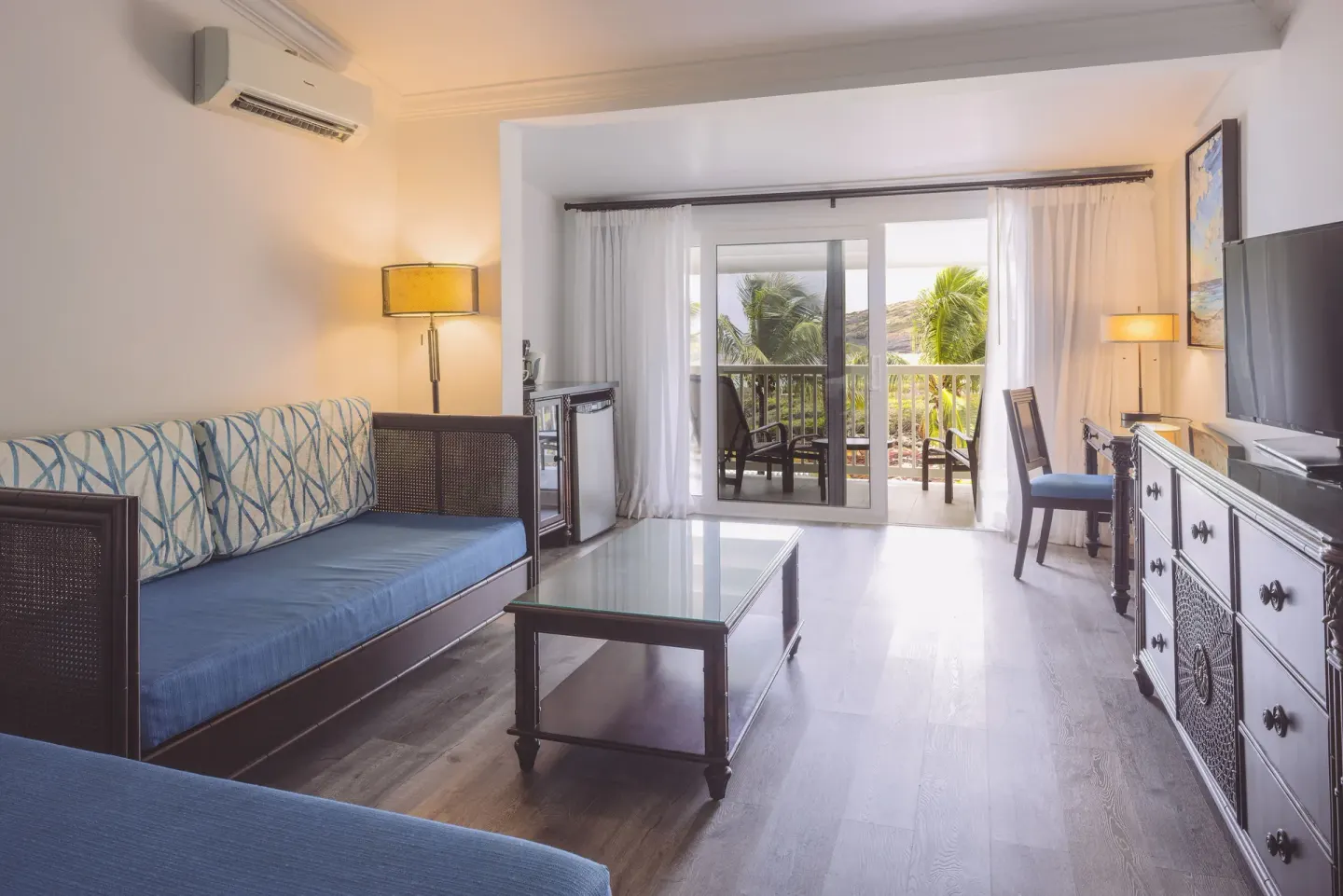 Junior Suite sitting area opening to a balcony at St. James's Club Antigua.