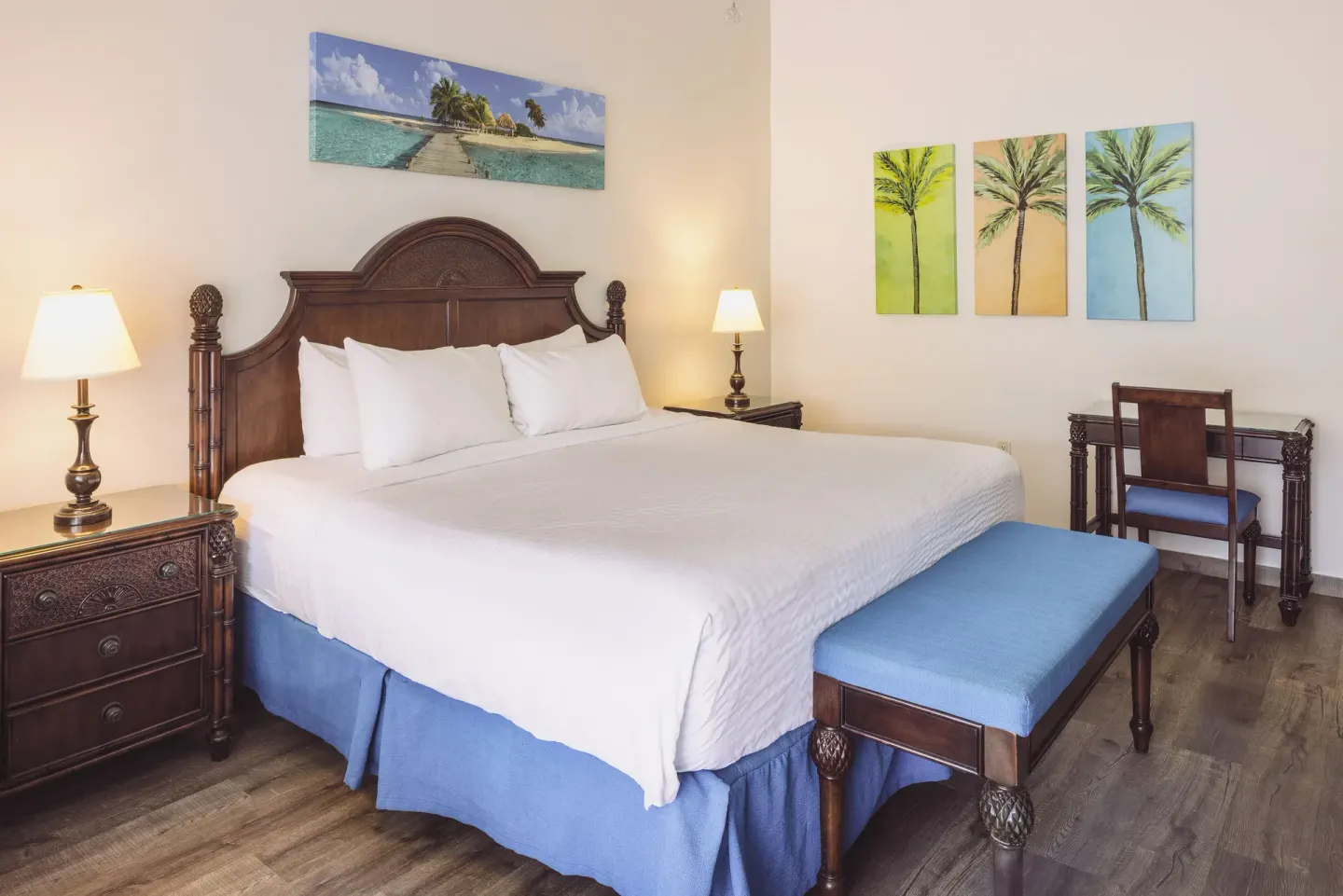 Premium Room with king bed, bench, desk, and tropical art at St. James's Club Antigua.