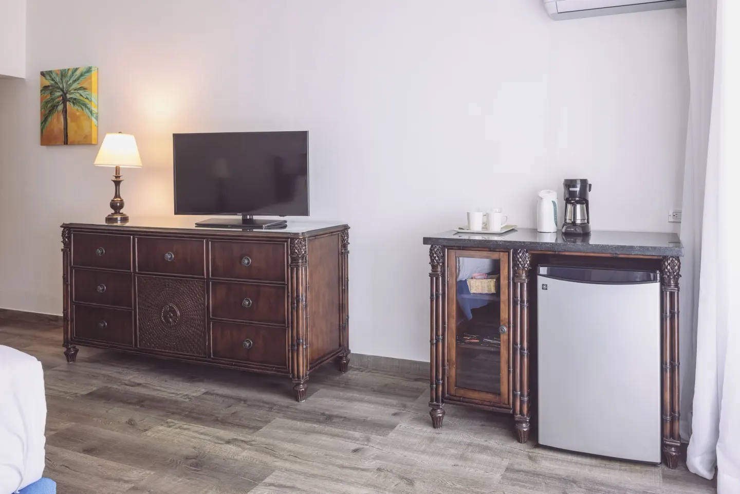 Premium Room dresser, TV, coffee setup, and mini fridge at St. James's Club Antigua.