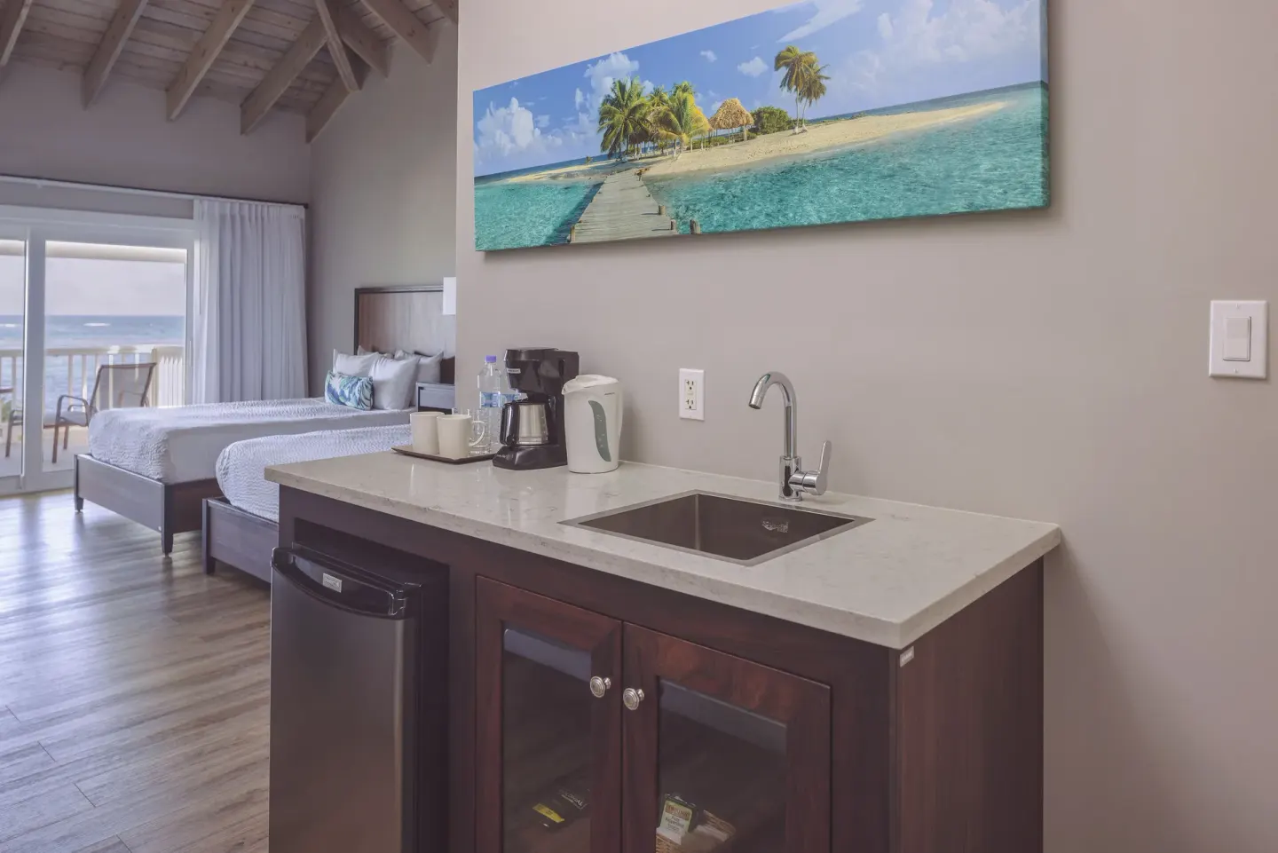 Beachfront room kitchenette with sink and coffee maker at St. James's Club Antigua.