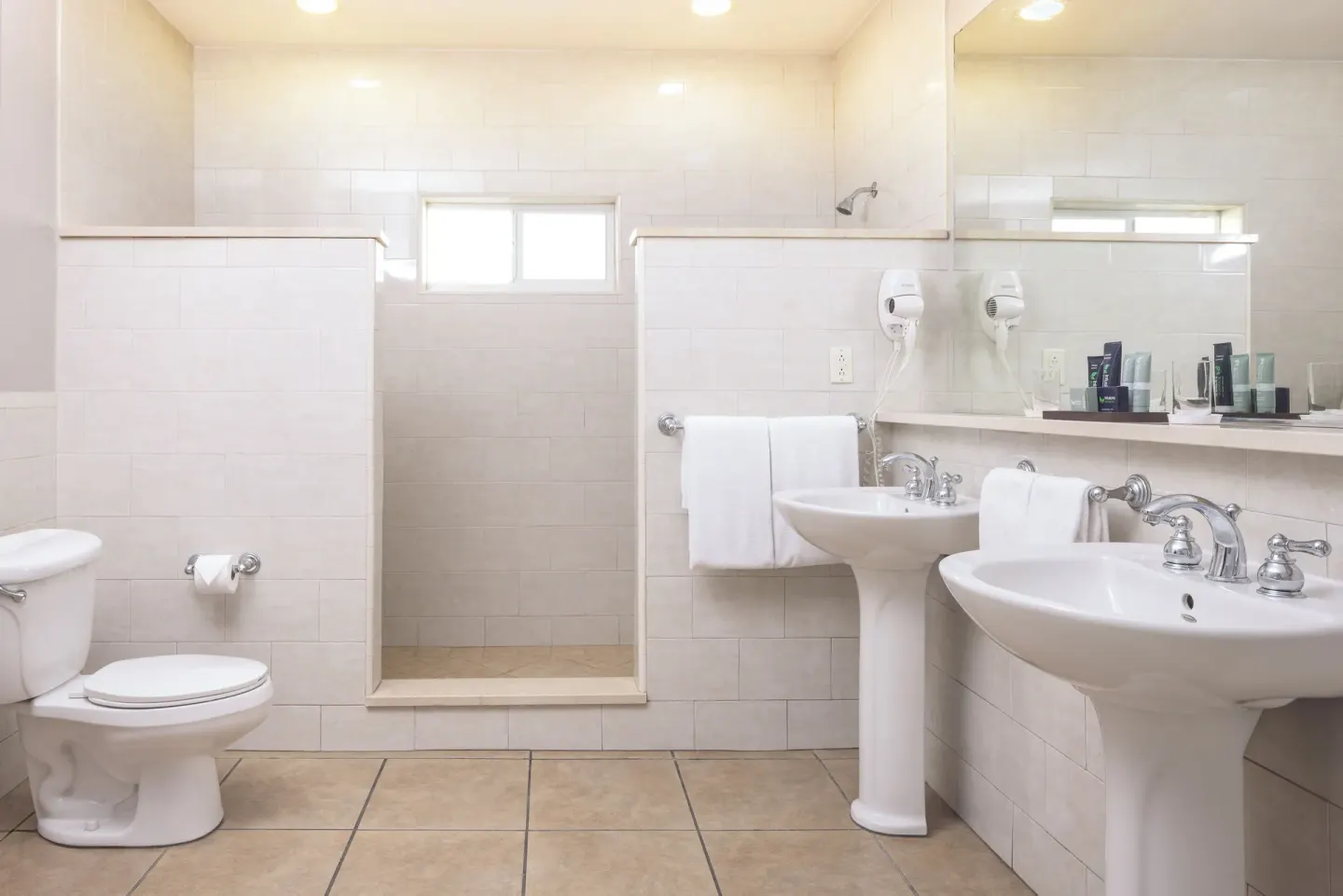 Royal Suite bathroom with walk-in shower and twin sinks at St. James's Club Antigua.