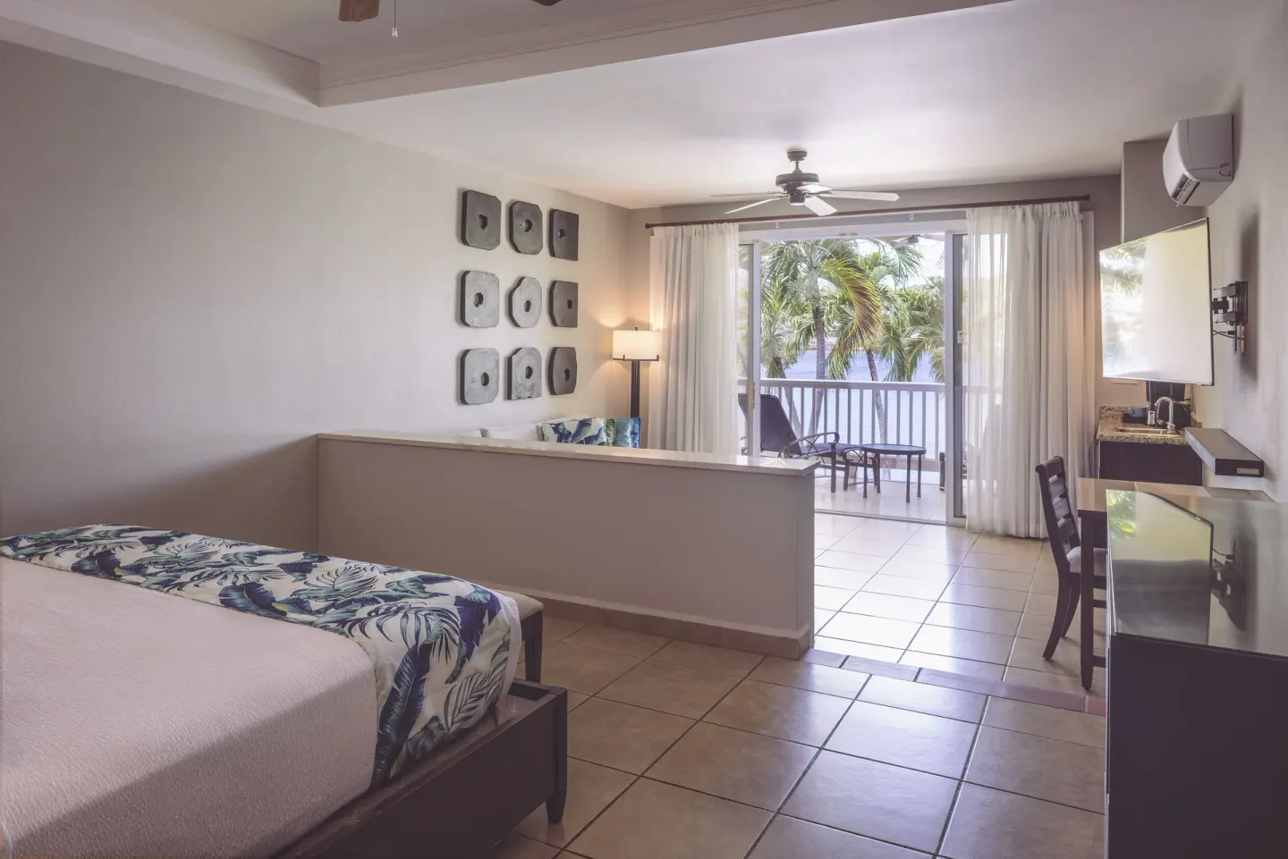 Royal Suite king bed and balcony sitting area at St. James's Club Antigua.