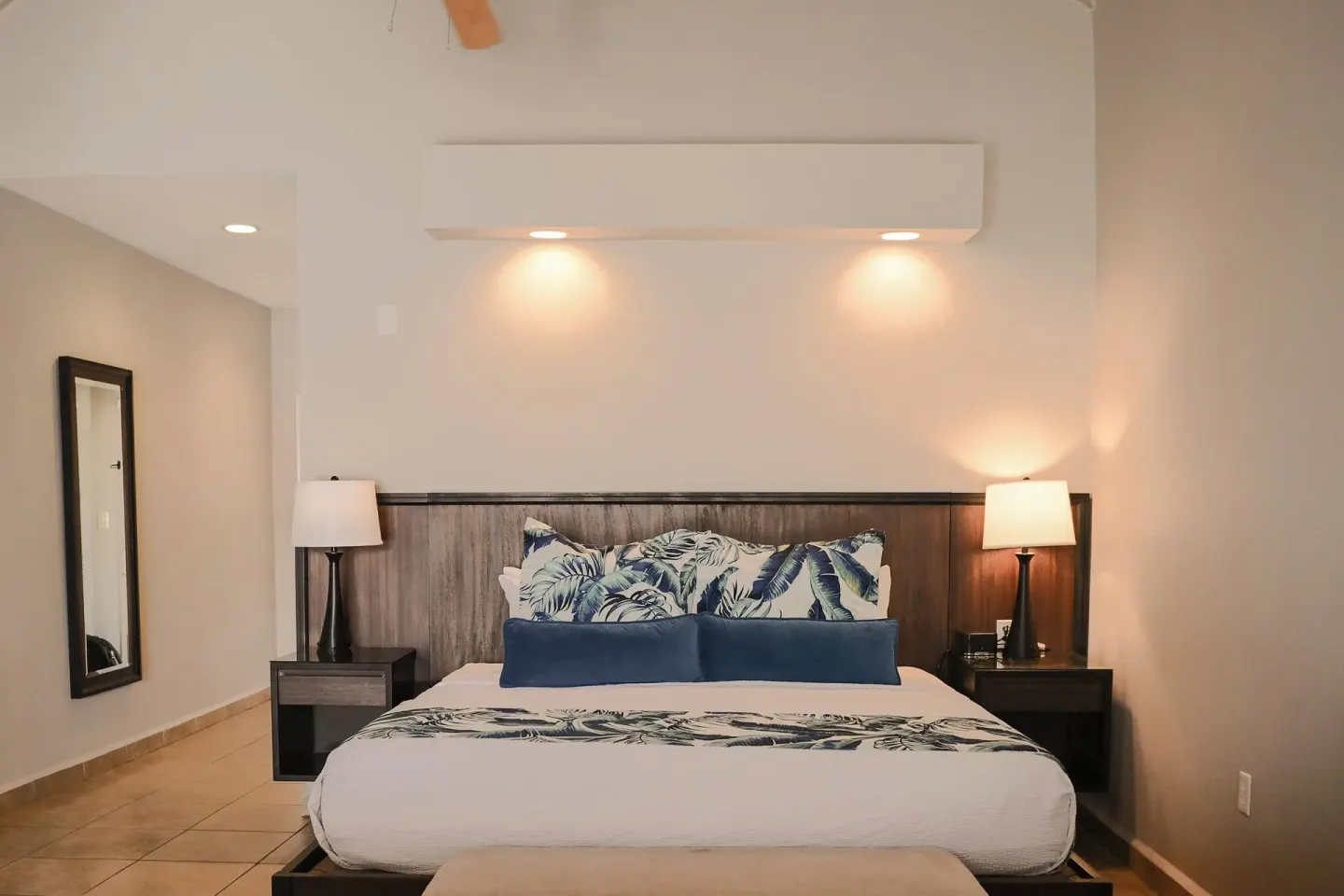 Royal Suite king bed with tropical pillows at St. James's Club Antigua.