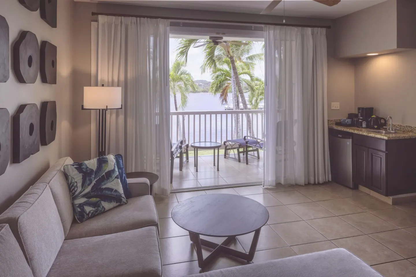 Royal Suite sitting area with wet bar and balcony at St. James's Club Antigua.