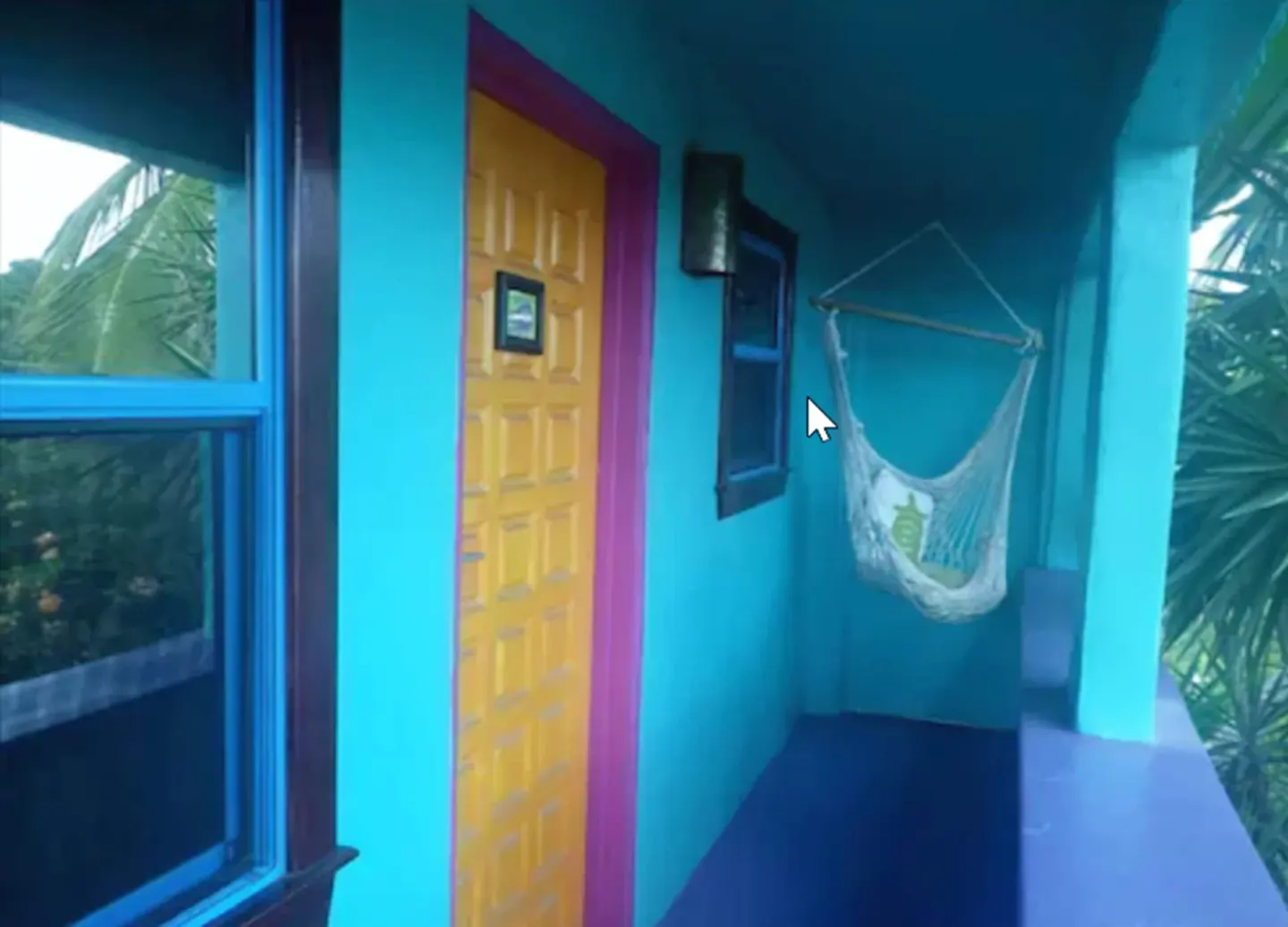 Colorful guest-room entry porch with hanging chair at St John Inn.