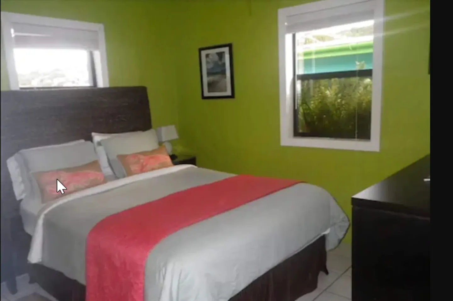 Standard Room bed with coral runner and green walls at St John Inn.