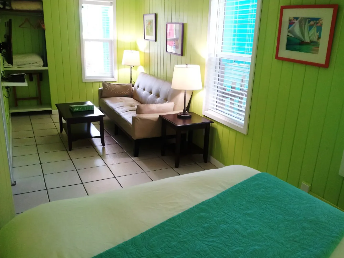 Superior Suite bedroom and sitting area with kitchenette doorway at St John Inn.